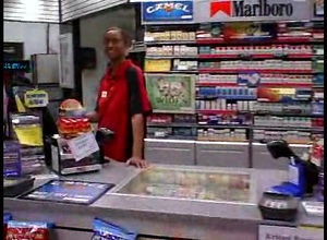 A ebony female working in a store blows